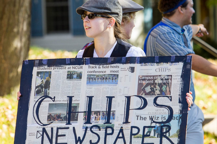 A Luther student holds a CHIPS sign during the homecoming parade