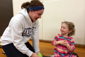 Social work major volunteering with a child from the community.