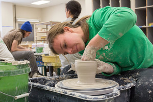 Luther students working in a pottery class.