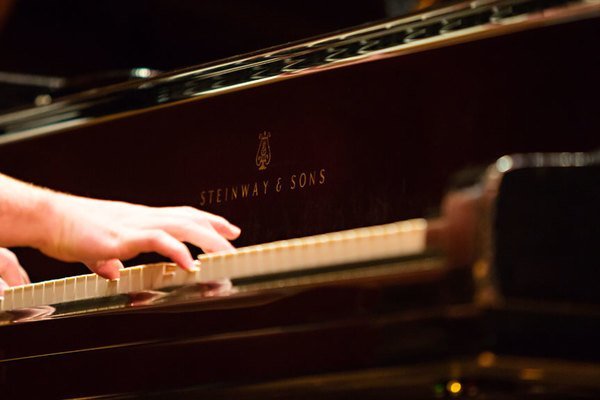 A close-up on someone playing piano.