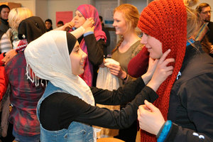 Muslim students help fasten hijabs