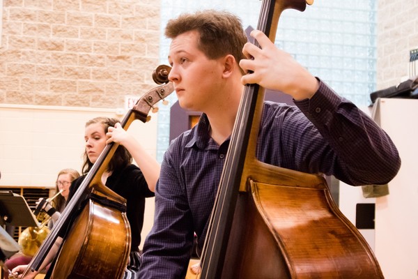 A double bassist in Chamber Orchestra rehearsing