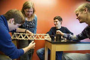 Professor Erin Flater inspects a bridge built by students in her Statics course.