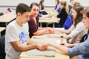Students learn about hand pressure points in the Exploring Alternative Medicine course.