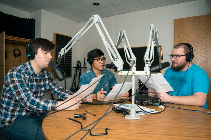 Three students works at KWLC, Luther's radio station, as part of their work study positions.