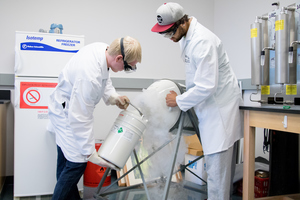 Two Luther students use liquid nitrogen for a student research project.