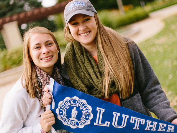 Students holding a Luther pennant.