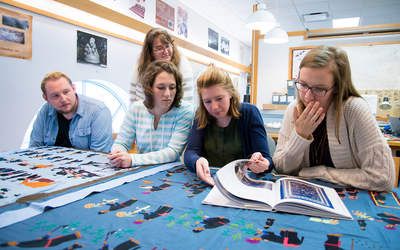 Anthropology student workers analyze and categorize a sizable collection.