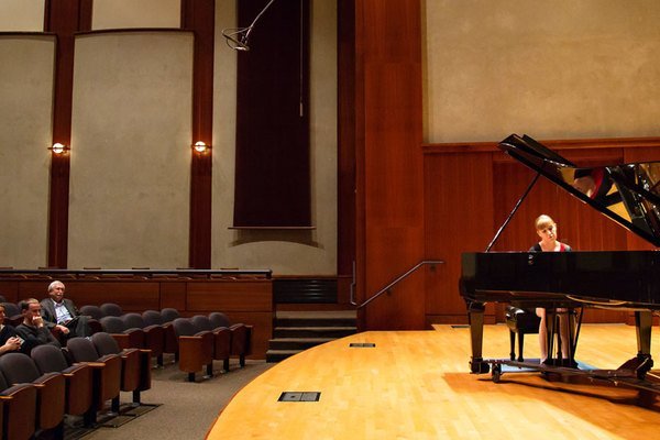 A student playing in piano seminar in the Noble Recital Hall.