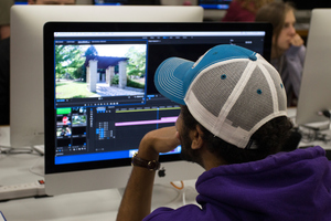 A Luther student edits a video for a multimedia course.