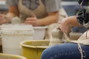 Students work with clay in a pottery class in the Center for the Arts.