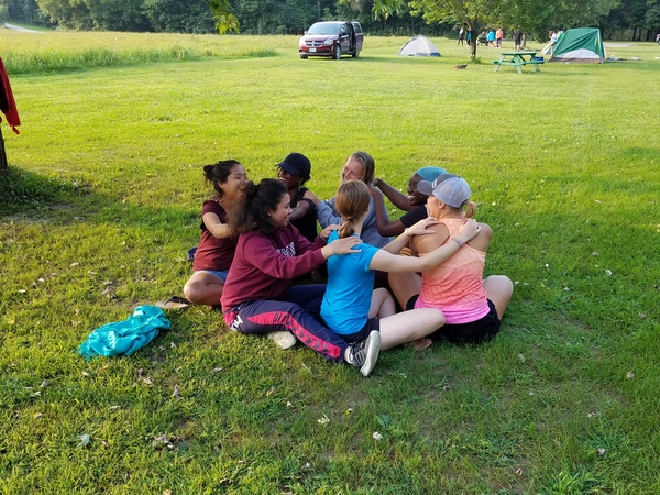 After setting up tents campers get into a massage circle