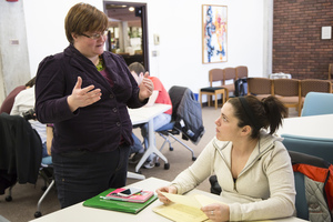Professor Lauren Anderson discussing a classroom project with a student.