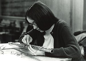 A student works on repairing a flute.