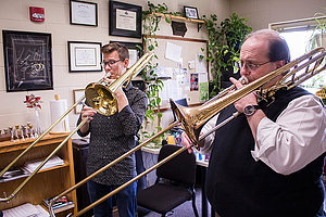 Dr. Mike Smith teaching a trombone lesson to a student.