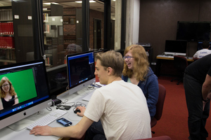 Two Luther students edit a video for a multimedia course.