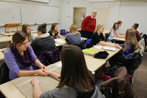Students learn about hand pressure points in the Exploring Alternative Medicine course.