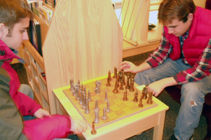Students playing chess in the Physics Library and Exploration Center.