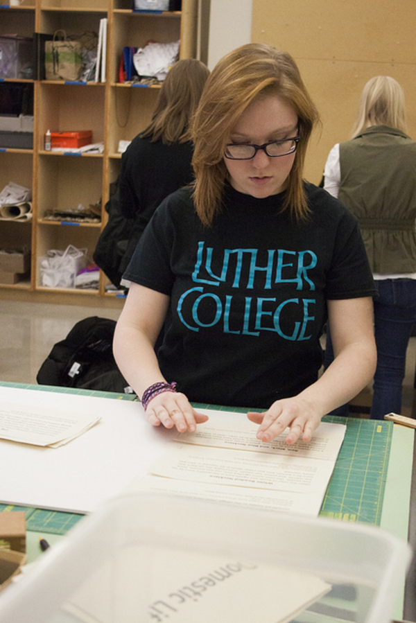 Taylor Kinley prepares exhibit labels for Olin display case.