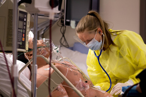 Nursing student participating in a burn simulation lab.