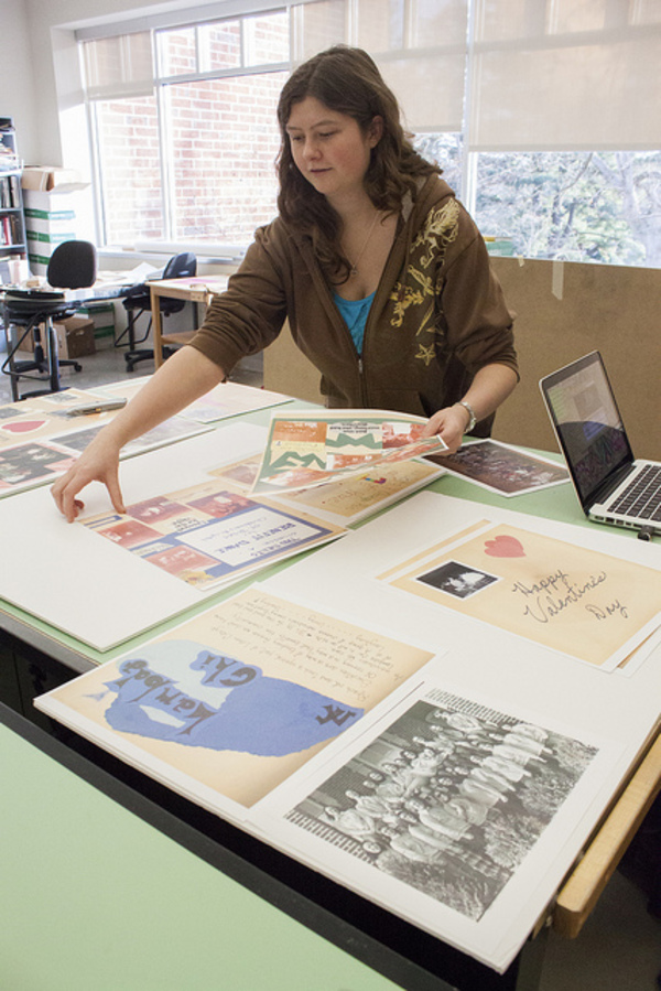 Velvet Warne prepares layout for exhibit planned for Preus Library.