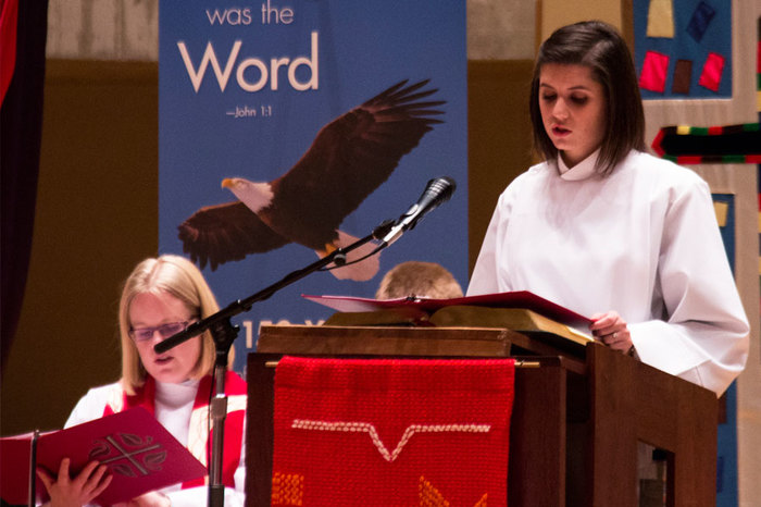 A student reads from the Bible during weekly chapel